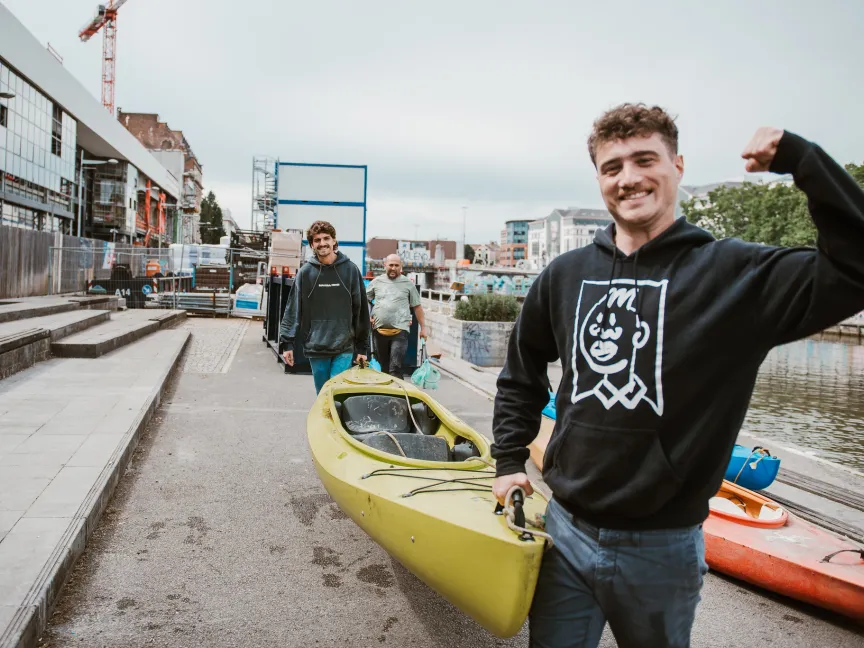2 men carrying a canoe together