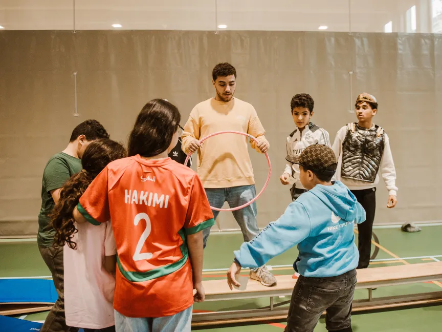 teens explaining a game to children