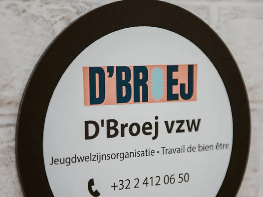 signage with D'Broej's logo and phone number