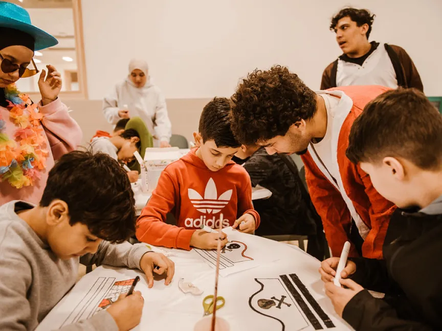 costumed volunteers with drawing children