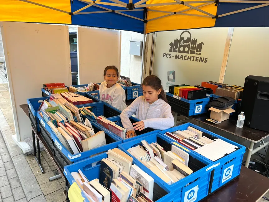 girls browsing boxes of books